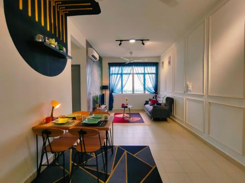 a room with a table and chairs and a living room at Desig Classic Falim by irainbow in Ipoh