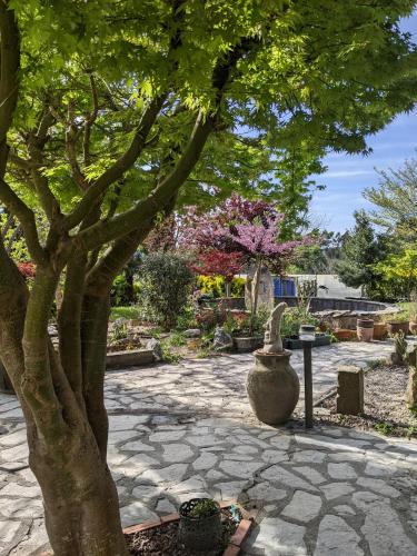 a tree and a vase sitting next to a tree at Casa Rural Bilbao Caserio Gondra Alquiler Habitaciones in Mungia