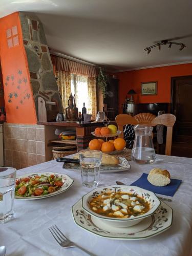 a table with plates of food on top of it at Casa Rural Bilbao Caserio Gondra Alquiler Habitaciones in Mungia