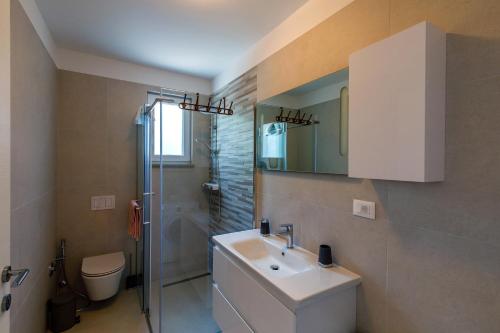 a bathroom with a sink and a shower and a toilet at Apartment "Villa M" in Kostrena