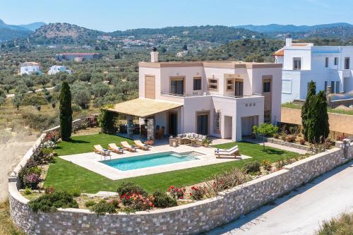 an aerial view of a house with a swimming pool at Majestic View Villa in Kolymbia