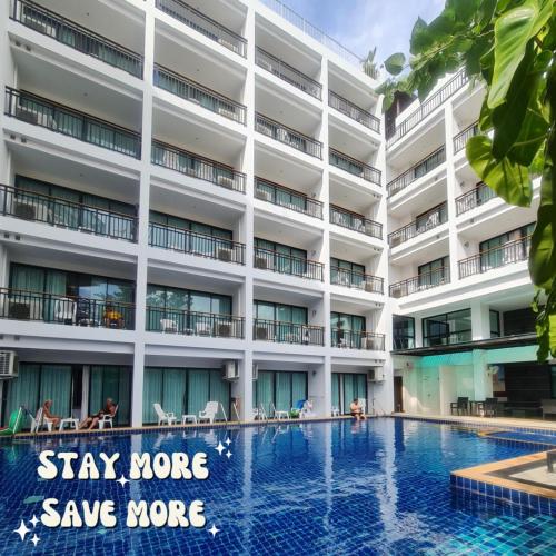 a hotel swimming pool in front of a building at Paripas Patong Resort in Patong Beach