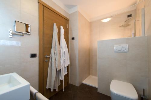 a bathroom with a toilet and a sink and a shower at Hotel Vedig in Santa Caterina Valfurva