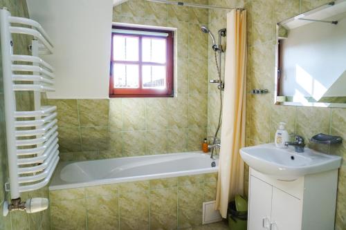 a bathroom with a bath tub and a sink at Domek Prezesa in Kazimierz Dolny