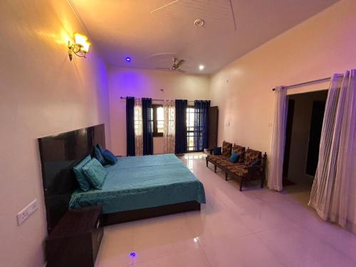 a bedroom with a bed and a couch in it at Bisht Niwas Homestay in Kotdwāra