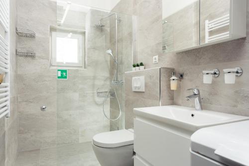 a bathroom with a toilet and a sink and a shower at HOUSE GAZO in Trogir