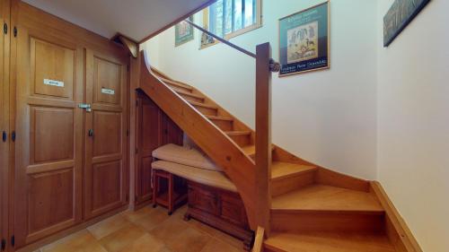 a staircase in a home with wooden cabinets at Warm chalet with a nice exterior in Les Marécottes in Les Marécottes