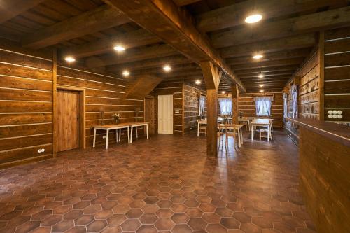 a large room with wooden walls and tables and chairs at Penzion U Zběhlíka in Svitavy