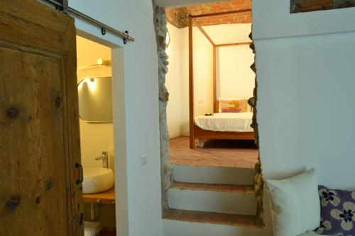 a bathroom with a sink and a bed in a room at La Locanda della Torre "Foresteria Lombarda" in Marne di Filago