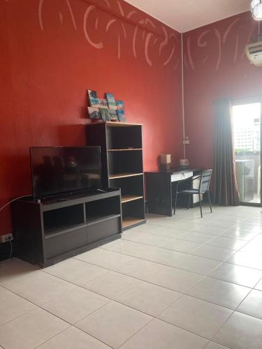 a living room with a flat screen tv and a table at Secrets - Pattaya in Pattaya