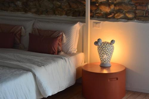 a bedroom with a bed and a vase on a table at La Locanda della Torre "Foresteria Lombarda" in Marne di Filago