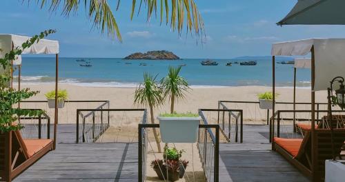 a beach with potted plants and the ocean at Seaside Boutique Resort Quy Nhon in Quy Nhon