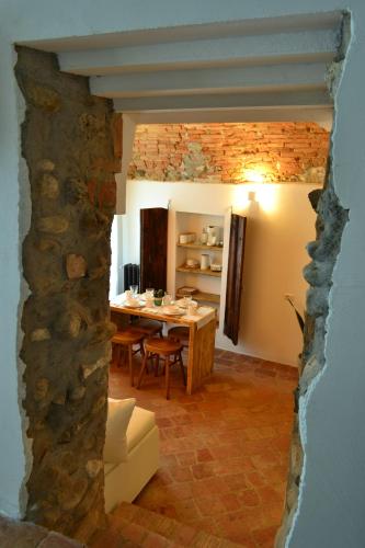 a dining room with a table and a stone wall at La Locanda della Torre "Foresteria Lombarda" in Marne di Filago