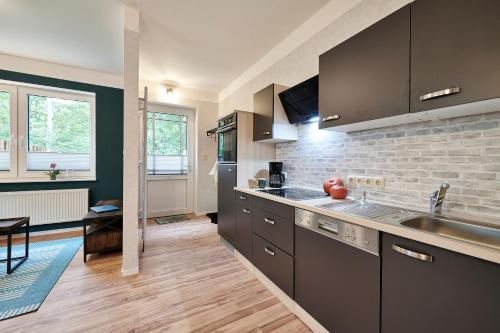 a kitchen with a sink and a counter top at Ferienwohnungen Stiller in Groß Rheide