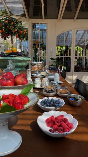 a long table with plates of food on it at Relais Villino Rubini in Brunate