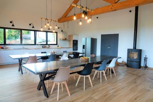 a large dining room with a large table and chairs at Gîte de l’Ambiance in Francheville