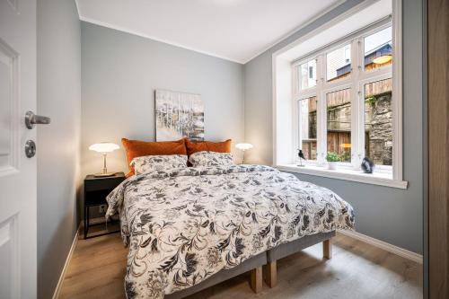 a bedroom with a bed and a window at Meltzers Apartments in Bergen