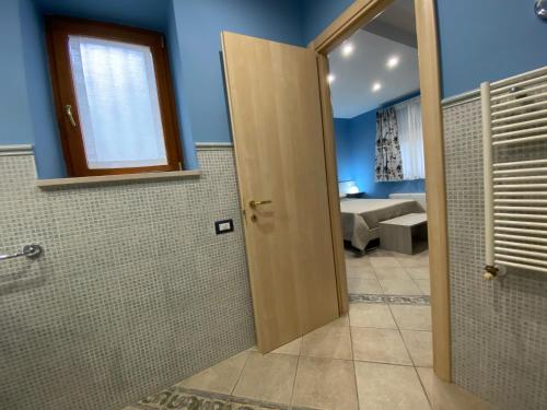 a bathroom with a door open to a room at Villa Vittoria in Matera