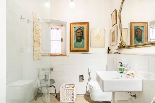 een witte badkamer met een wastafel en een toilet bij Country House With Garden&Private Parking! in Livorno