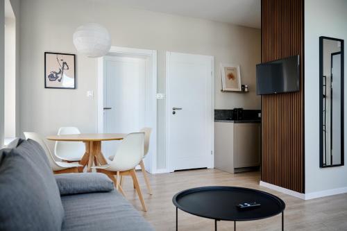 a living room with a couch and a table at THE HOUSE near Lake & Old Town in Olsztyn