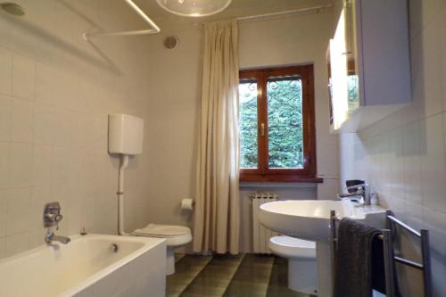 a bathroom with a tub and a toilet and a sink at Villetta Mazzini Front Lake - Happy Rentals in Peschiera del Garda