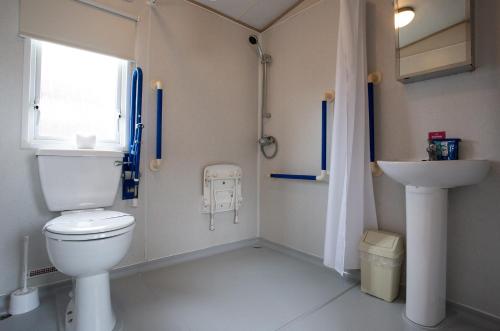a bathroom with a toilet and a sink at Mersea Island by Away Resorts in Colchester
