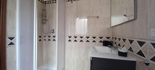 a bathroom with a sink and a shower at Alloggio turistico a Via Modugno in Vitinia