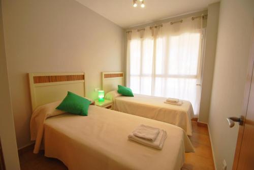 A bed or beds in a room at Apartamentos Nova Denia - Deniasol
