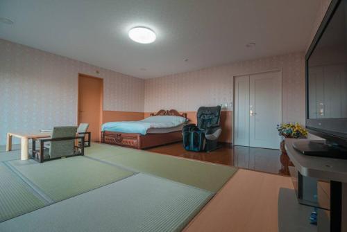 Voodi või voodid majutusasutuse 札幌西野夢幻夜景附庭院 Sapporo Night View House toas