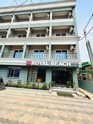 a white building with a royal beach sign on it at Royal Beach International in Puri