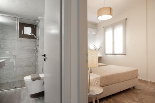 a small bathroom with a bed and a shower at Diov Bohali House in Zakynthos