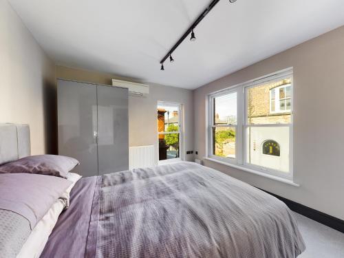 a bedroom with a large bed and a window at 18 Palm Hill, Oxton in Upton