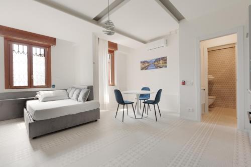 a bedroom with a bed and a table and chairs at Milano Renovated Studio APTS in Milan