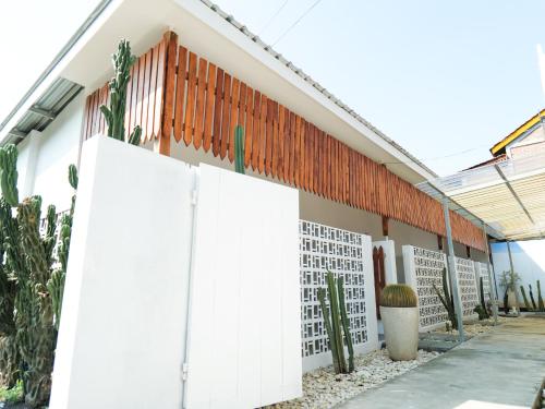 a building with white doors and cactus at Cactus Guest House Borobudur in Borobudur