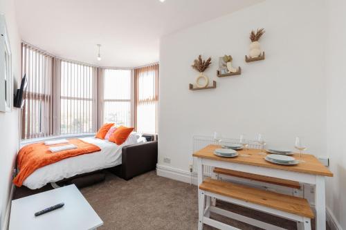 a bedroom with a bed and a desk in it at Cherry Property - Grapefruit Suite in Blackpool