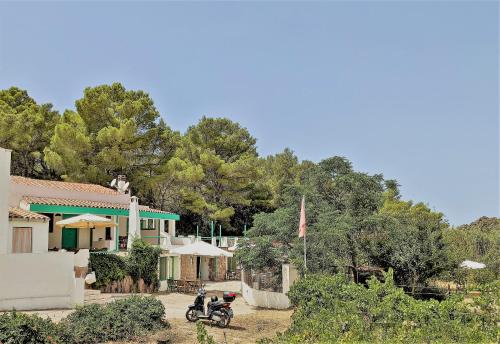 a motorcycle parked in front of a house at Cala Vinagra House in Carloforte