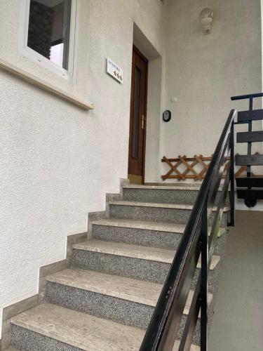 a set of stairs leading up to a door at Apartma Magnolija in Nova Gorica
