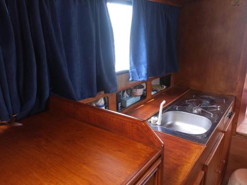 a small kitchen with a sink and a window at Ubytování na námořní jachtě in Veselí nad Moravou