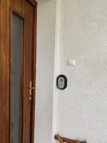 a alarm clock on a wall next to a door at Apartma Magnolija in Nova Gorica