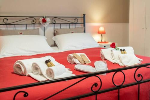 a bed with white towels and pillows on it at Terrazze Italiane City Center - RED APARTMENT in Verona