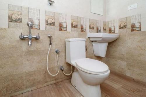 a bathroom with a toilet and a sink at Westernghats Homestay in Madikeri