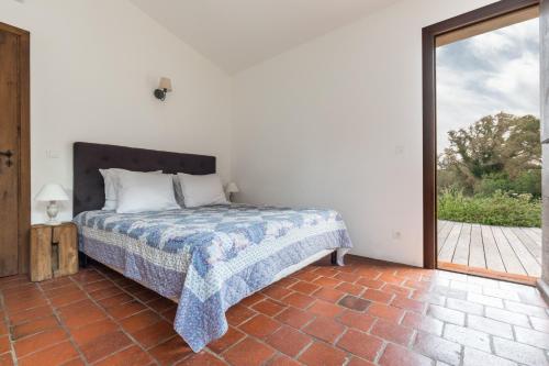 a bedroom with a bed and a large window at Casa di Pruno in Figari