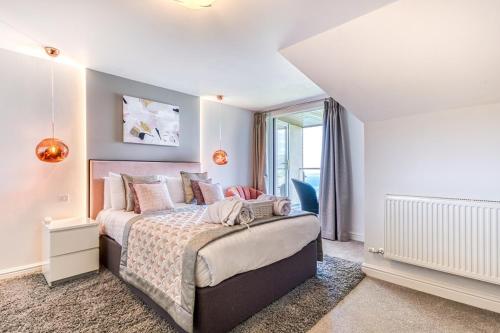 a bedroom with a bed and a large window at Sandy Cove Hotel in Ilfracombe