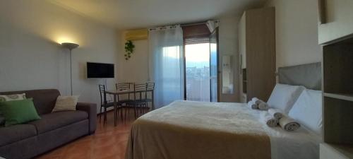 a hotel room with a bed and a couch at Alloggio turistico a Via Modugno in Vitinia