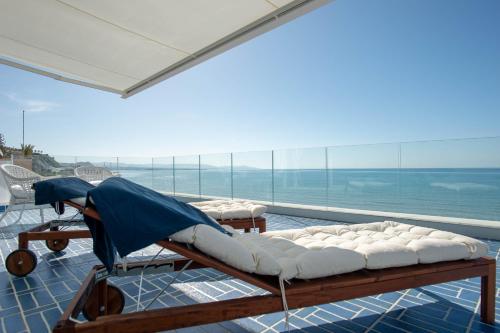 a room with two beds and a view of the ocean at B&B Mammaliturchi SCALA DEI TURCHI in Realmonte