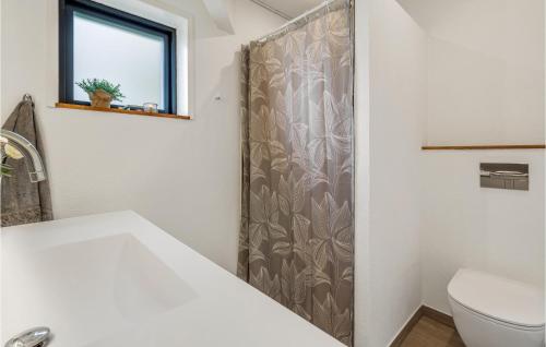 a bathroom with a toilet and a shower curtain at Awesome Home In Sydals With Wifi in Sønderby