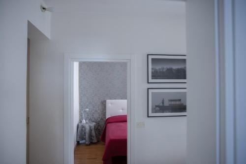 a bedroom with a bed and two pictures on the wall at San Maurizio Apartment in Venice