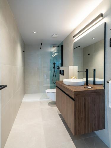 a bathroom with a sink and a toilet at Hotel Villa Rosetta in Savudrija