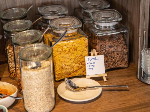 a table with many jars of nuts and seeds at Hotel Villa Rosetta in Savudrija