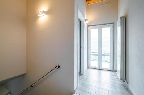 an empty hallway with an open door and a stairway at Comfy & Roomy Apt - View on the Ligurian Hills! in Vezzano Ligure